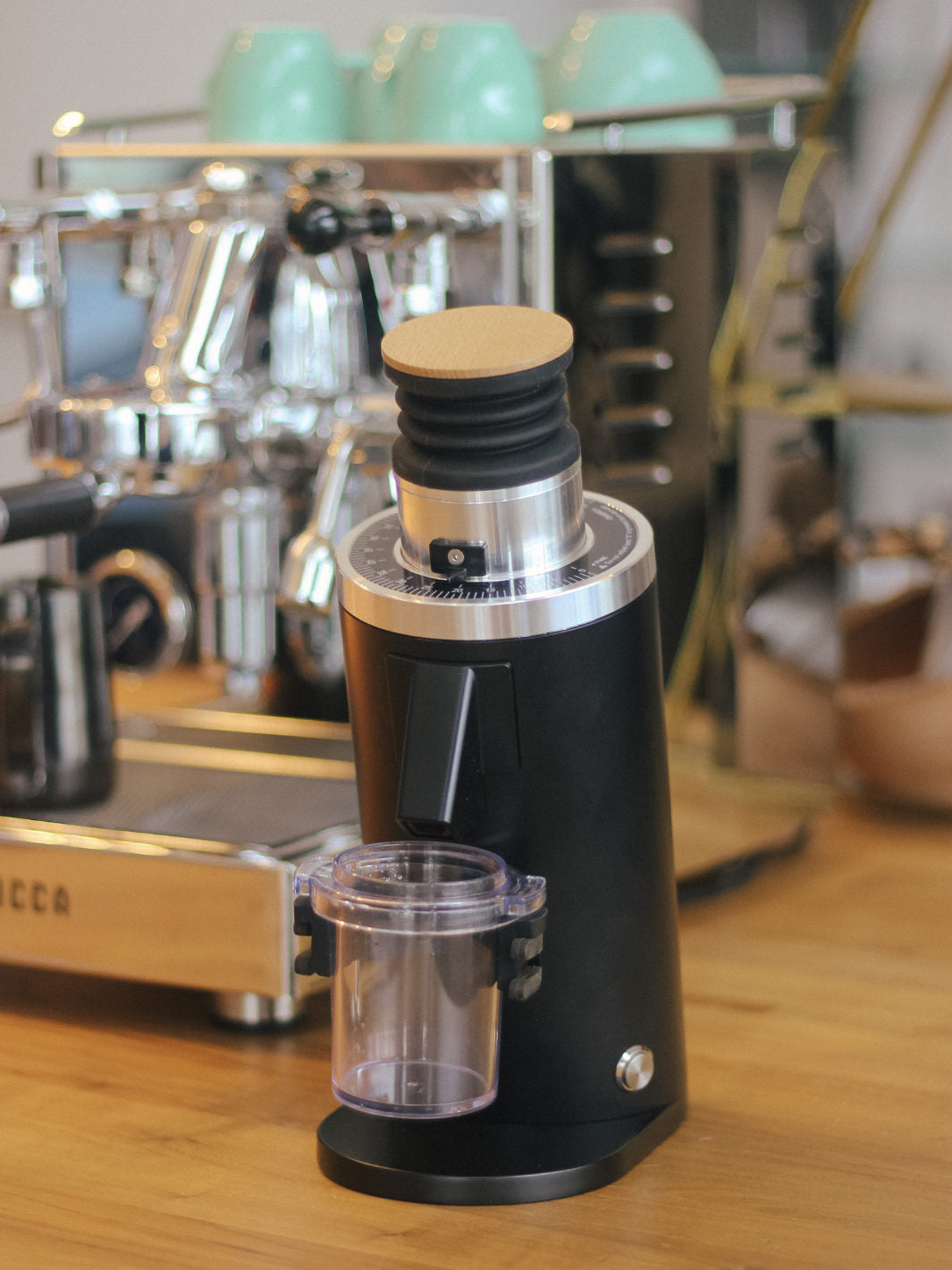 A Black DF 54 All Purpose grinder next to the LUCCA X58 Espresso Machine