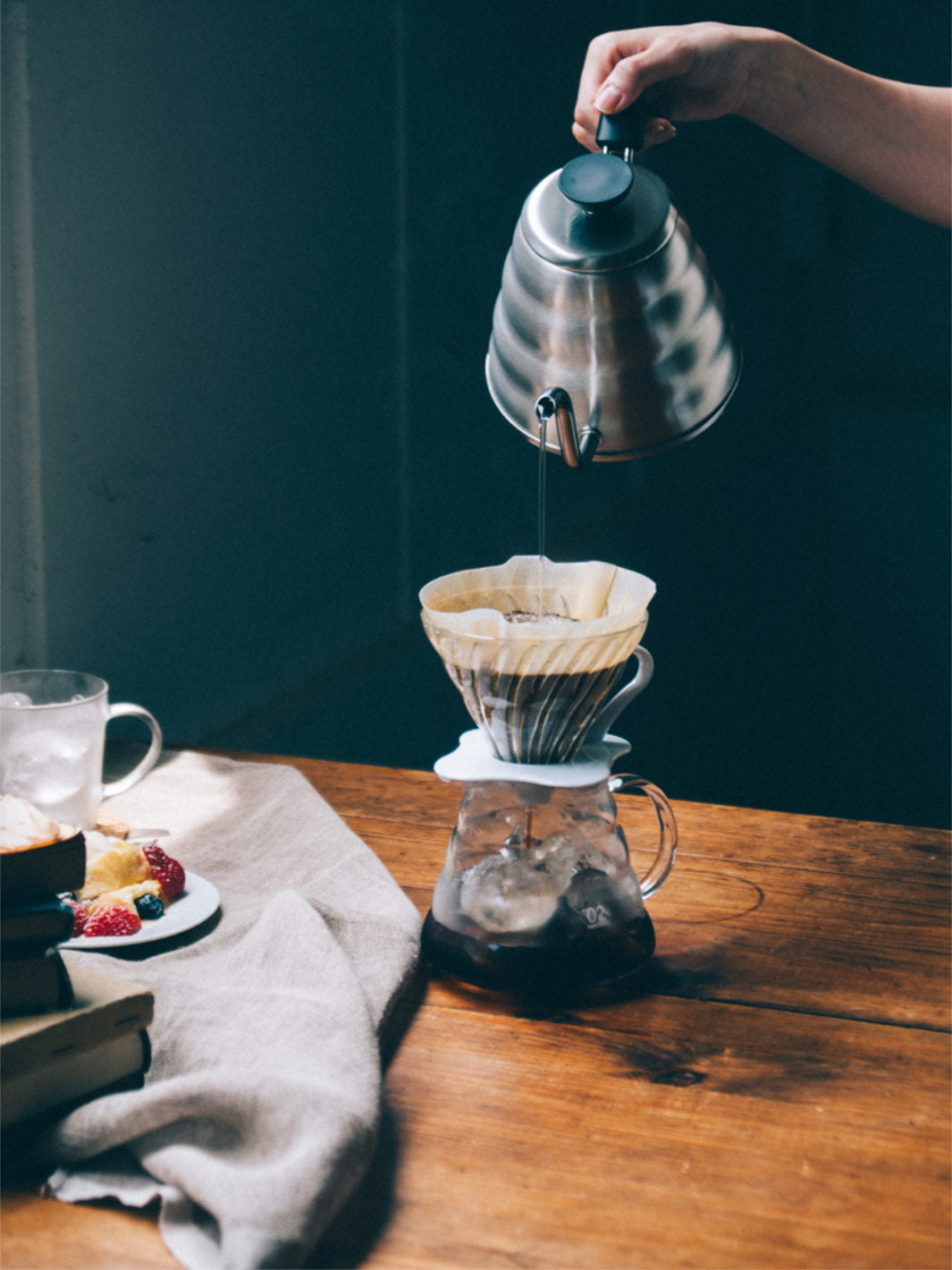 Hario kettle pouring over a V60 brewer and coffee server