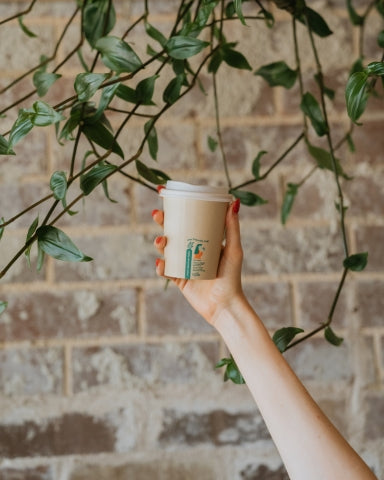 person holding a Little Green Panda Friendly Cup