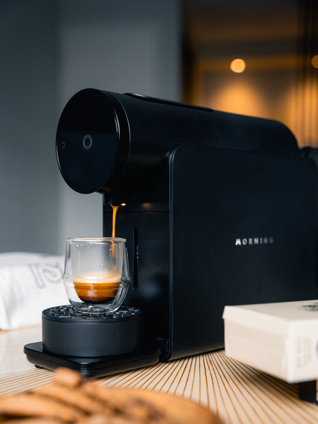 MORNING Machine brewing a coffee into a glass cup