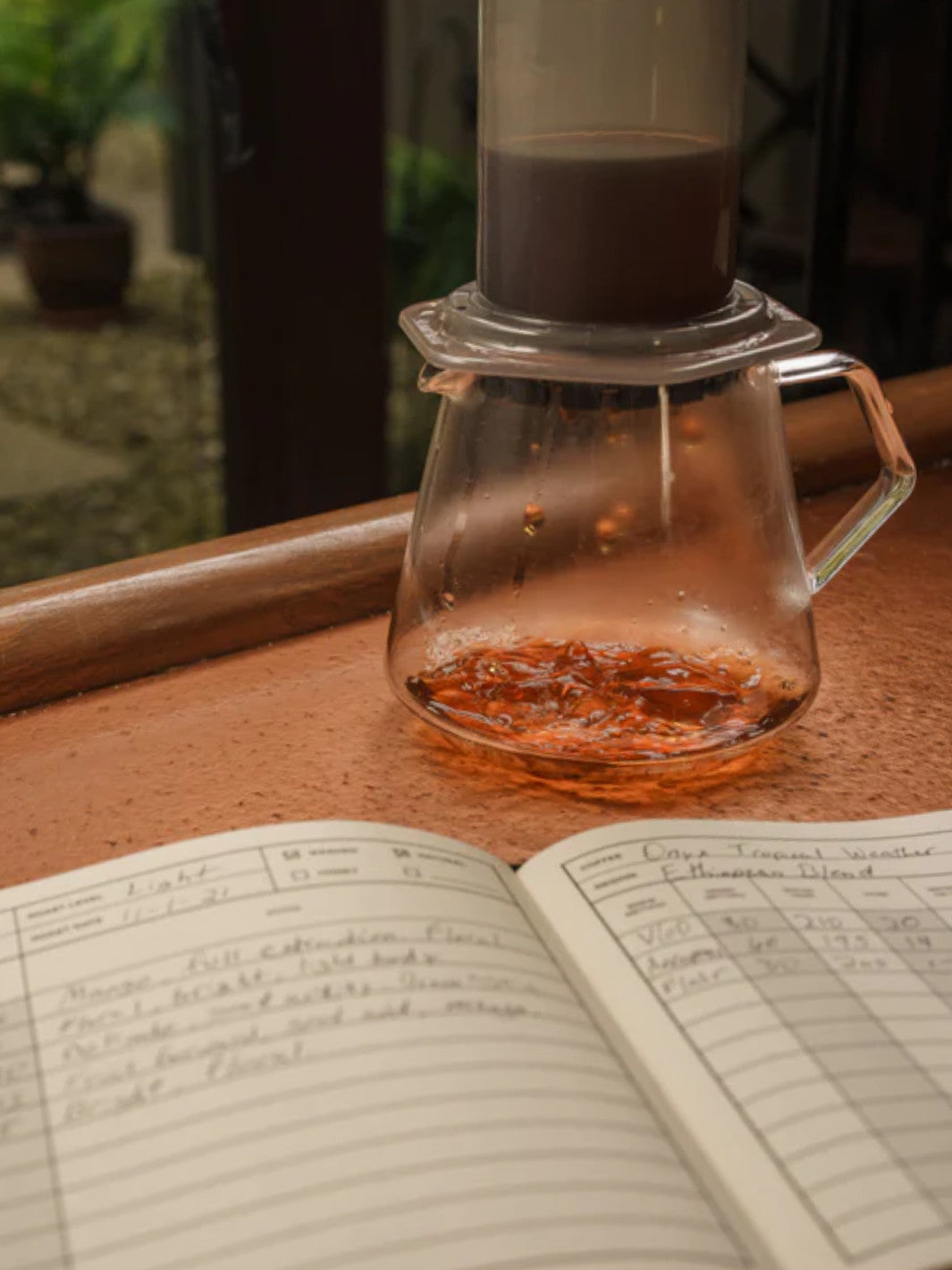 A AeroPress Coffee Maker on a clear Carafe. 